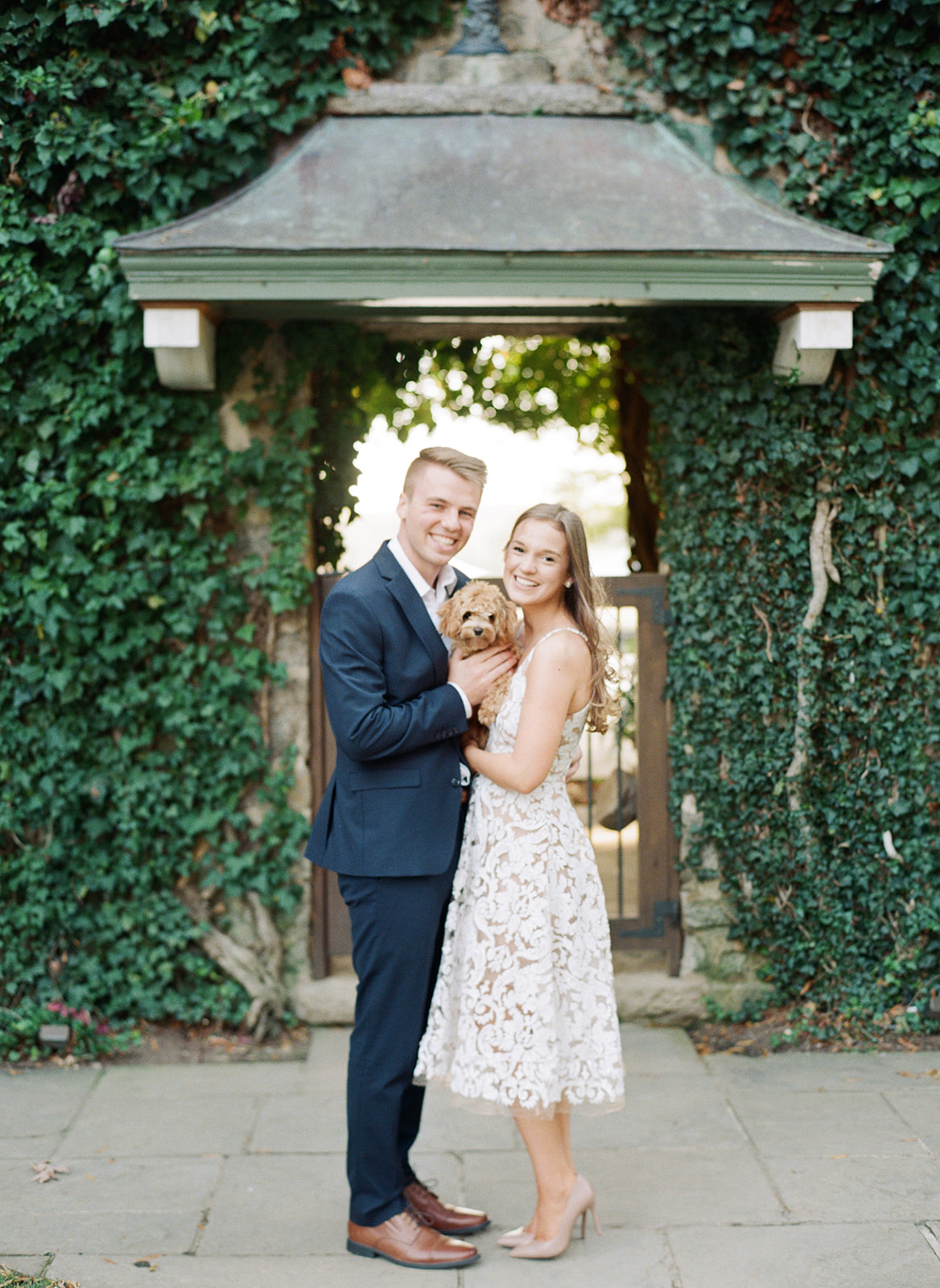 Couple at engagement session holding dog at Goodstone Inn in Virginia