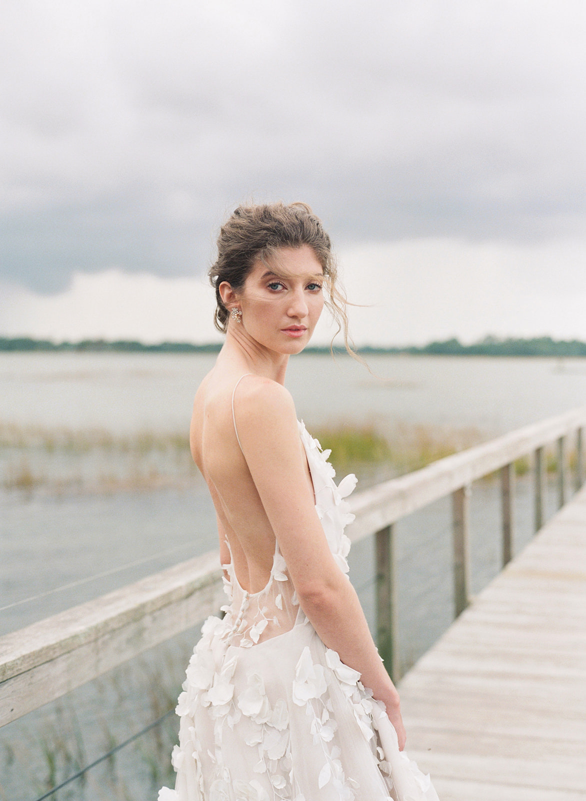 Bride in white dress on the dock at Lowndes Grove in Charleston SC