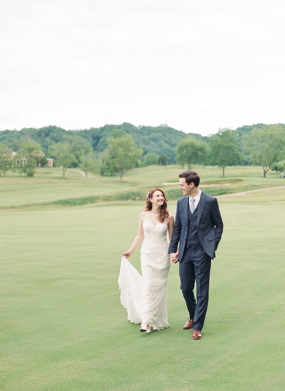 Bride and Groom holding hands on the golf course at the Olde Farm in Viriginia